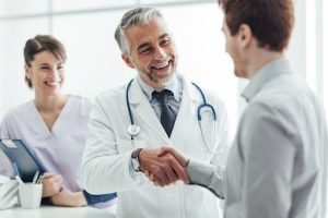 Physician greeting a candidate during healthcare recruitment outreach